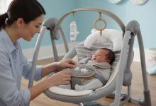 Parent securing baby in Ingenuity Swing 'n Go Deluxe with five-point harness for safety