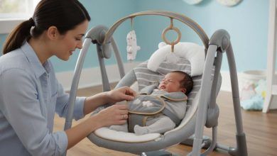 Parent securing baby in Ingenuity Swing 'n Go Deluxe with five-point harness for safety