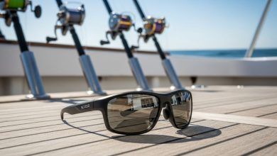 High-quality polarized fishing sunglasses with corrosion-resistant frames displayed on boat deck with saltwater fishing rods in background