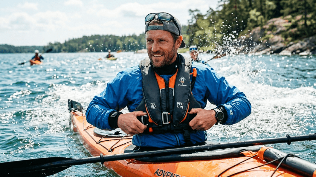 Kayak fisherman using auto inflate vest during offshore fishing trip