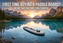 A turquoise lake with a paddle board and the text: First Time Buying a Paddle Board?