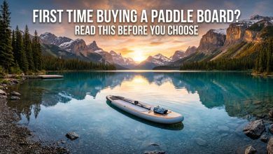 A turquoise lake with a paddle board and the text: First Time Buying a Paddle Board?