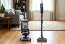 Side-by-side comparison of an upright Shark vacuum and a cordless Shark vacuum on a clean living room floor