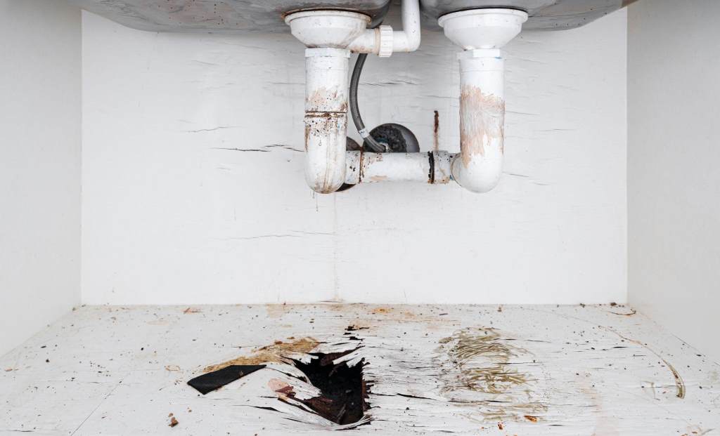 Outdoor plumbing pipes exposed to sunlight showing heat damage in Phoenix yard
