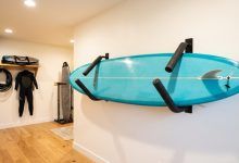 Surfboard stored safely on an indoor wall rack.