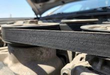 Mechanic inspecting a serpentine belt in Phoenix