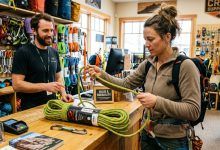 Climber examining a durable climbing rope at an outdoor gear store.