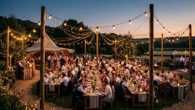 Warm string lights illuminating a budget-friendly outdoor wedding reception setup at dusk.
